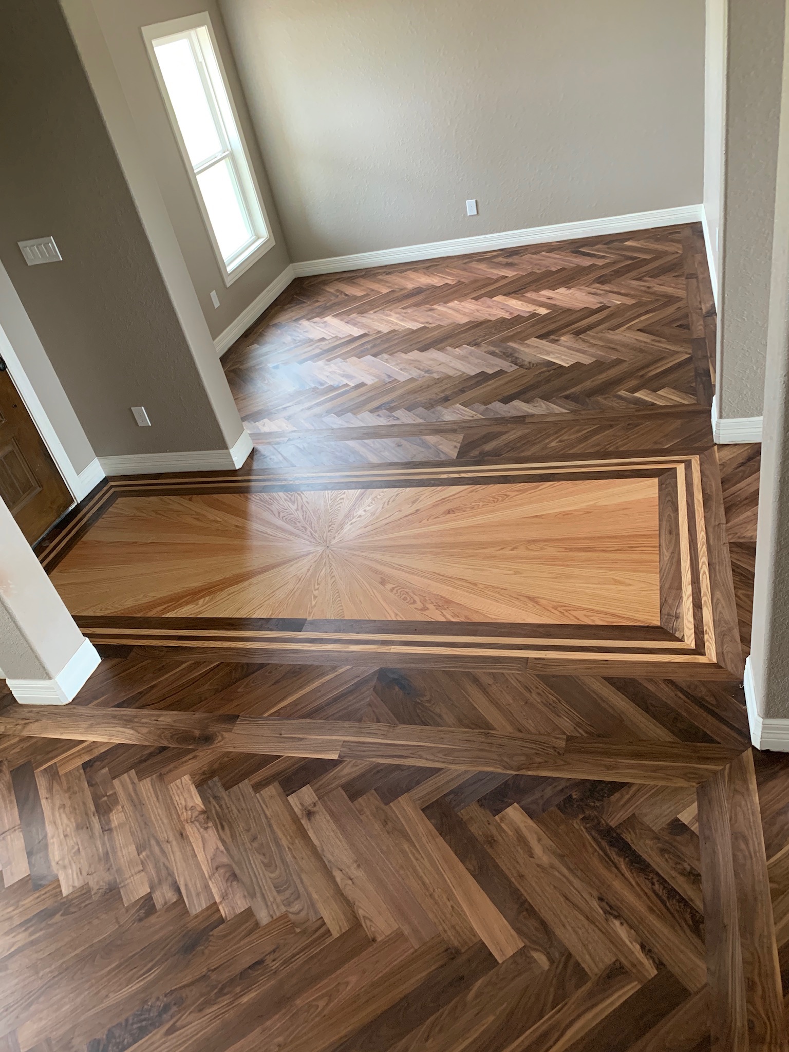 solid hardwood installation, herringbone patter, custom entry design, WFA's Custom Hardwood Floors, houston texas